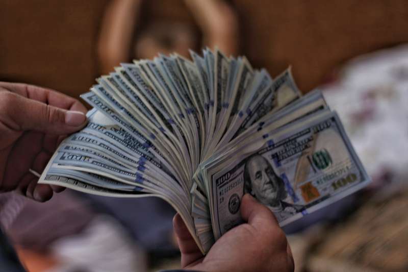 Man Counting Cash, Emphasizing Financial Security